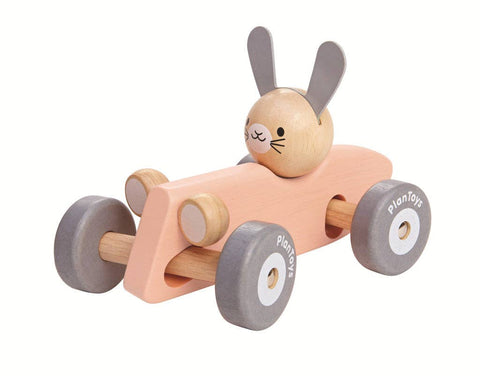 Wooden toy car with a rabbit design on a white background