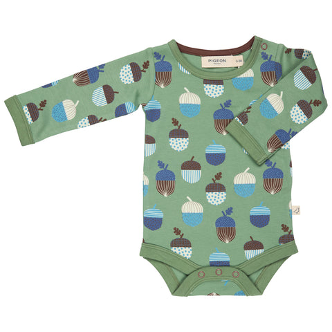 Green baby vest with acorn pattern on a white background