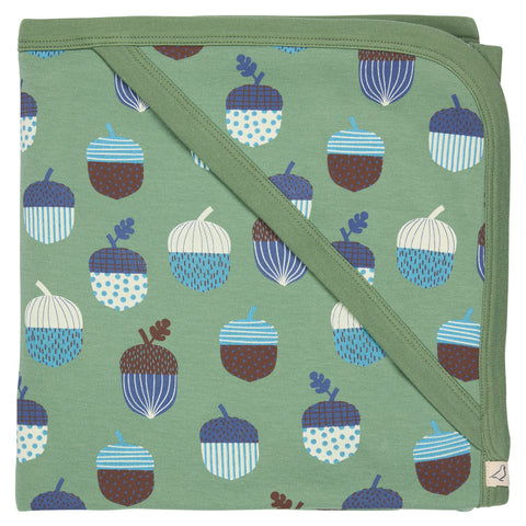 Folded green blanket with acorn pattern on a white background