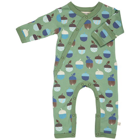 Green baby onesie with acorn pattern on a white background