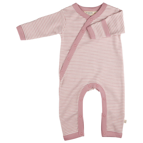 Pink and white striped baby romper on a white background